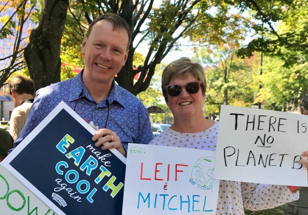 two people holding signs