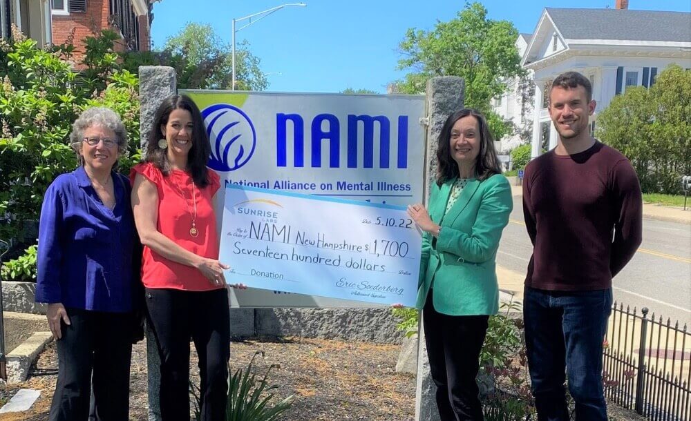 4 Sunrise Labs employees holding the NAMI sign